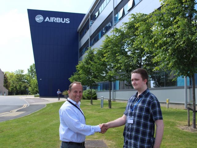 Cameron Sidders, student, shakes hands with David Best, Head of Strategy & Business Development at Airbus